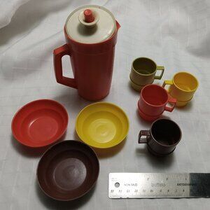 Set of vintage Tupperware cups, bowls, plate, and pitcher children's set